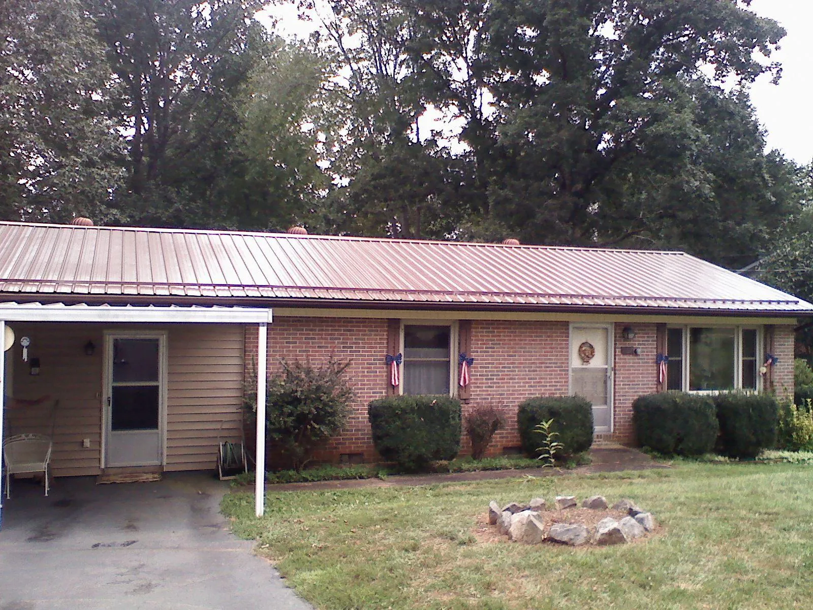 Bronze metal roof and carport on a brick ranch home — Roof Repair work by our crew in Toms River