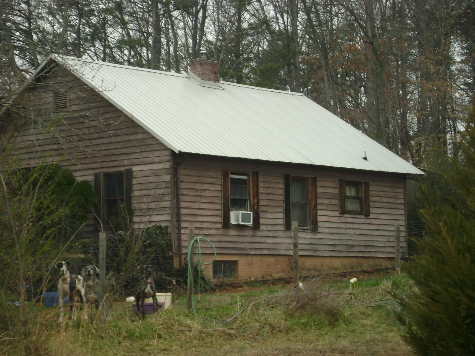 White metal roof on an old wood sided farmhouse, from a Asphalt Shingle Roof Repair job in Toms River